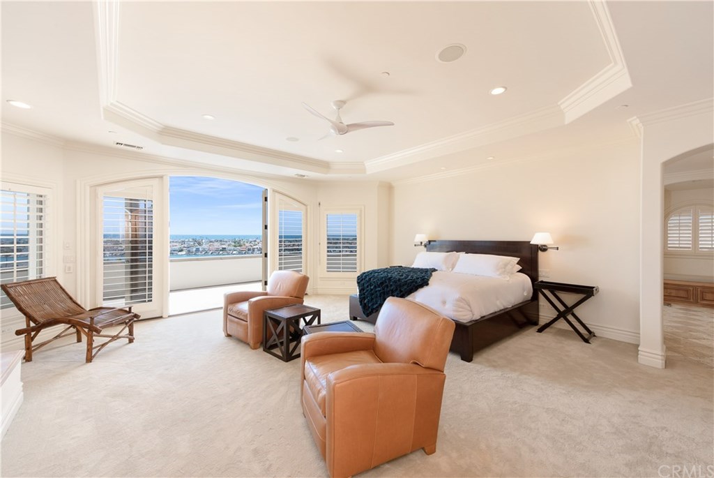 911 Kings Road Newport Beach, CA 92663 - Photo 17 of 47 a bedroom with furniture and large windows