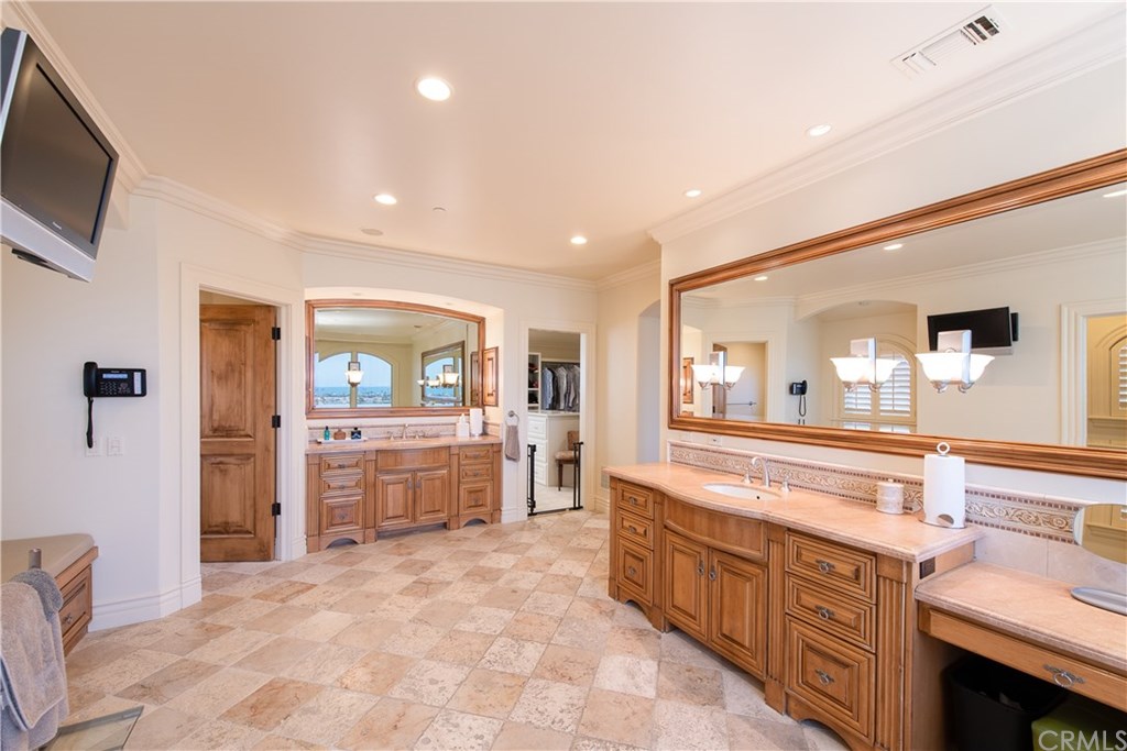 911 Kings Road Newport Beach, CA 92663 - Photo 26 of 47 a large bathroom with a large mirror vanity and sink