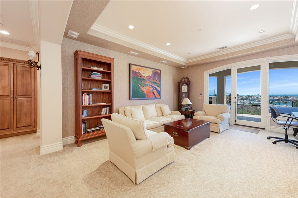 911 Kings Road Newport Beach, CA 92663 - Photo 32 of 47 a living room with furniture and a book shelf