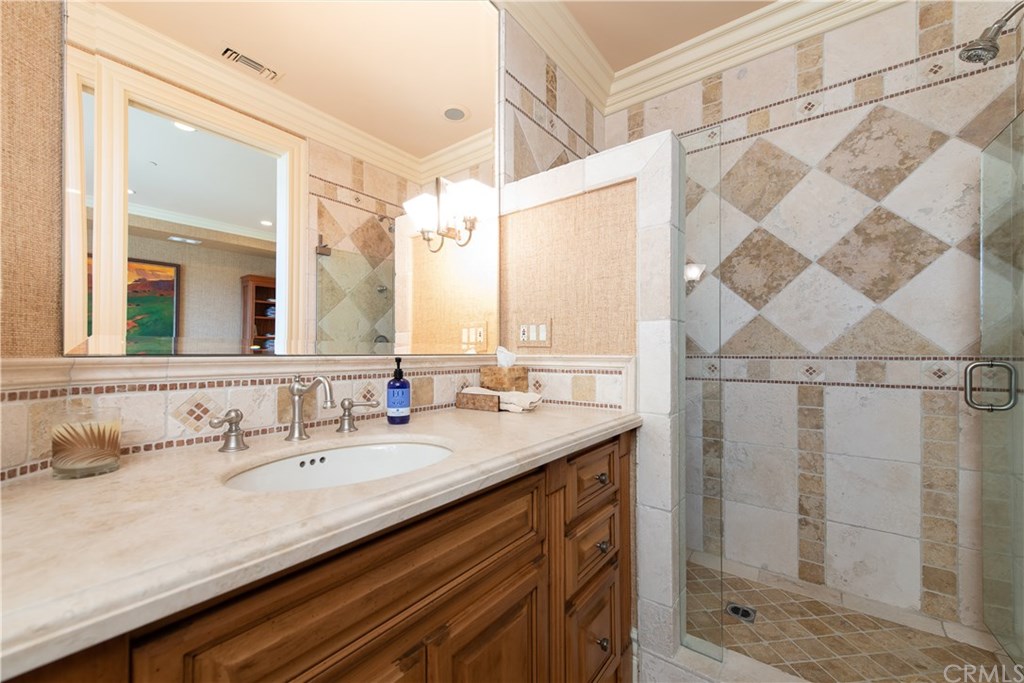 911 Kings Road Newport Beach, CA 92663 - Photo 37 of 47 a bathroom with a granite countertop sink and a mirror