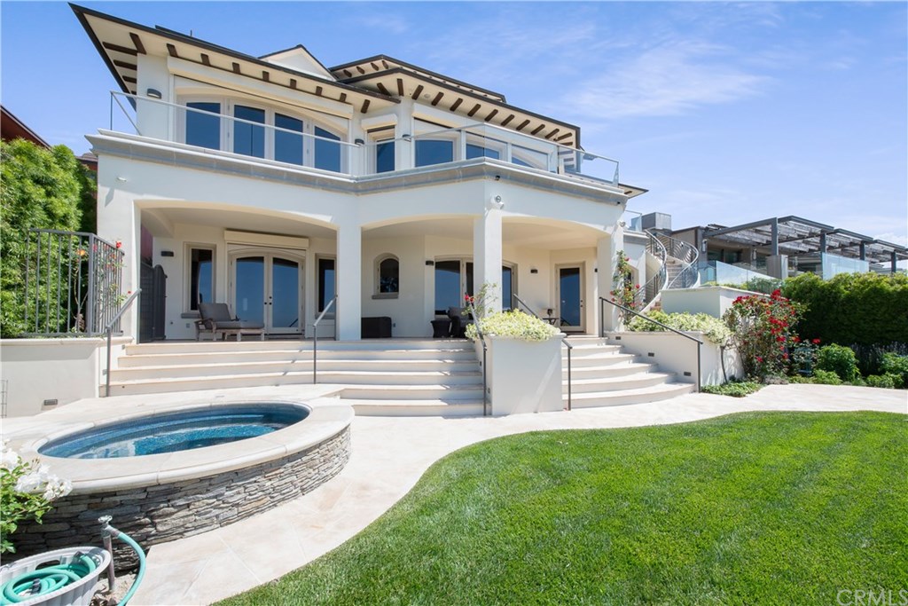 911 Kings Road Newport Beach, CA 92663 - Photo 43 of 47 a view of a house with a swimming pool and a yard