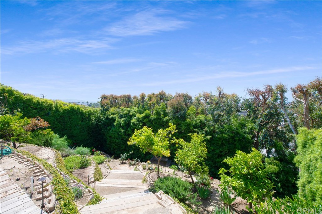 911 Kings Road Newport Beach, CA 92663 - Photo 44 of 47 a view of a garden with a building in the background