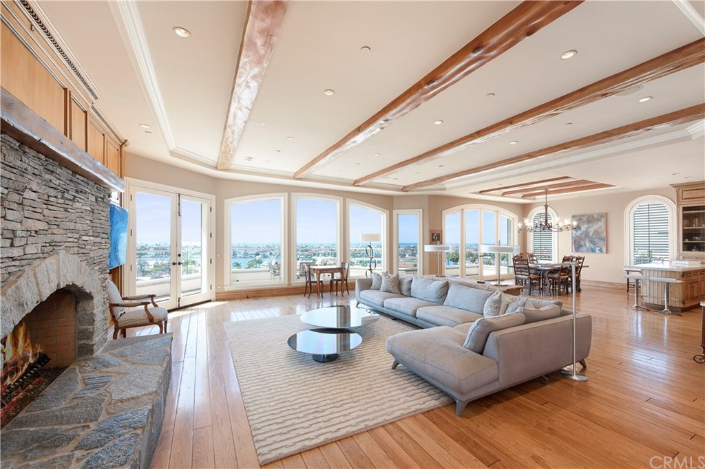 911 Kings Road Newport Beach, CA 92663 - Photo 9 of 47 a living room with furniture fireplace and a large window