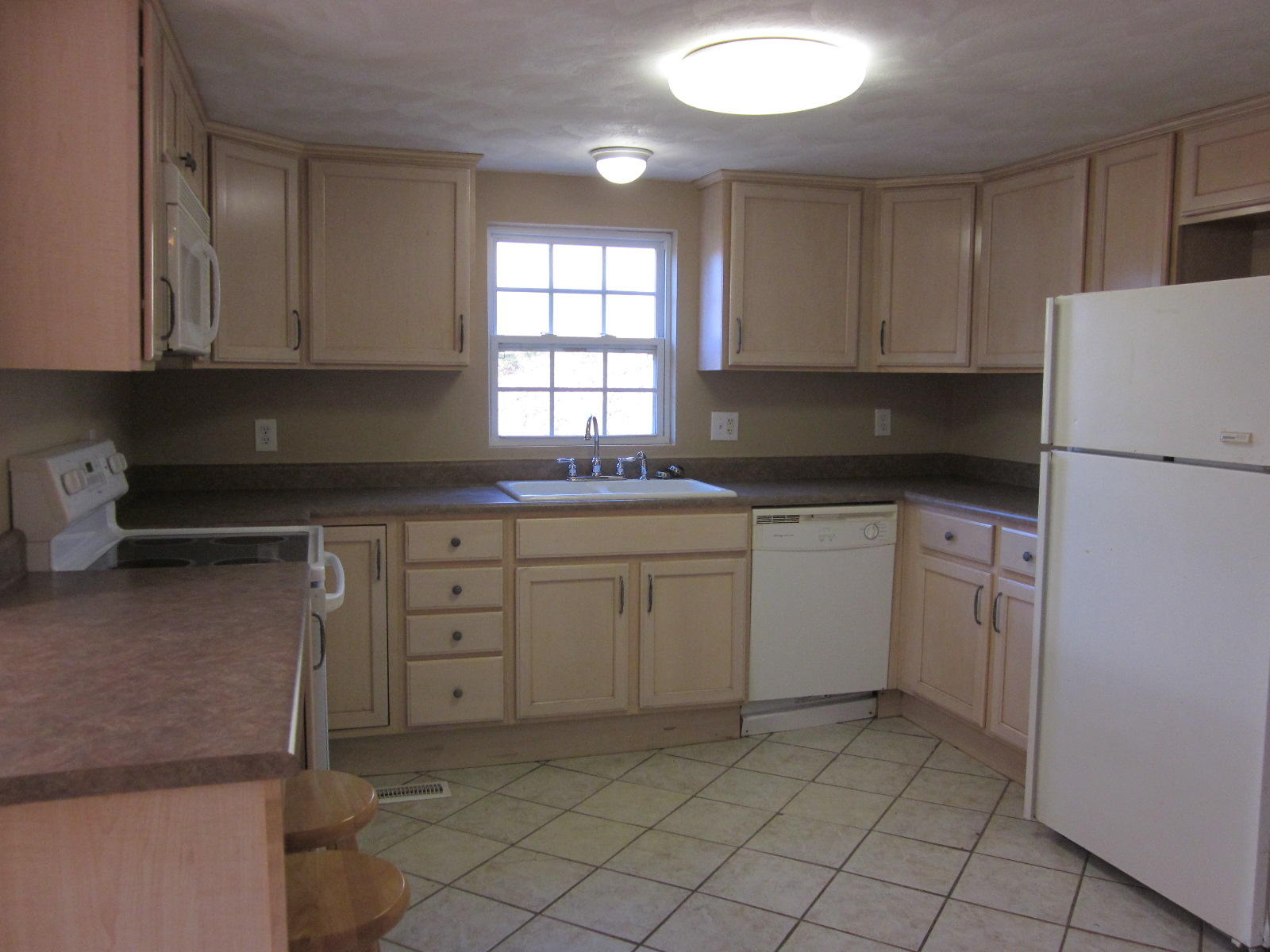 1885 Old Forge Road Callaway, VA 24067 - Photo 14 of 48 a kitchen with white cabinets and white appliances