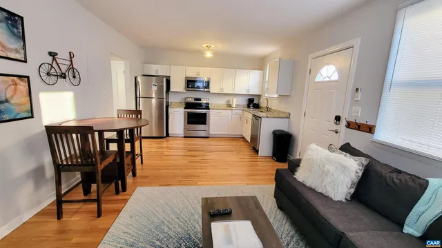 a living room with furniture wooden floor and a fireplace
