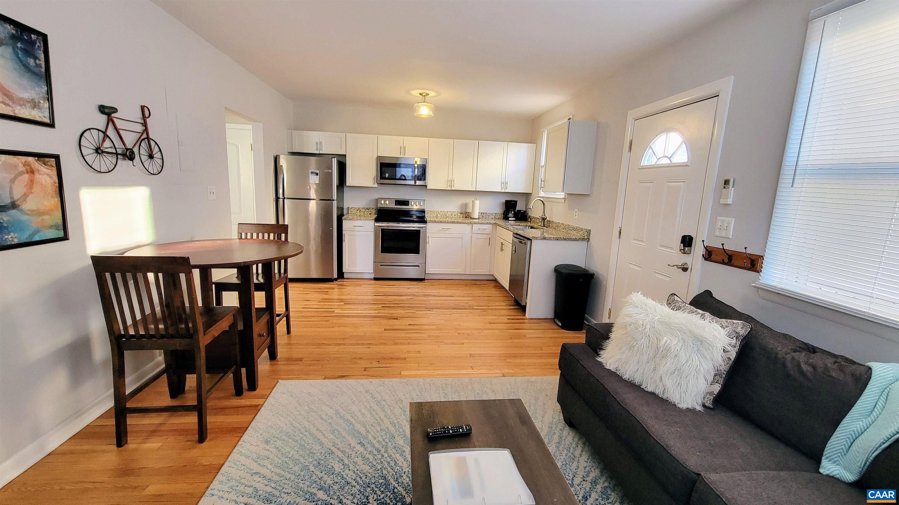 1511 East High Street, Unit 1 Charlottesville, VA 22902 - Photo 1 of 19 a living room with furniture wooden floor and a fireplace