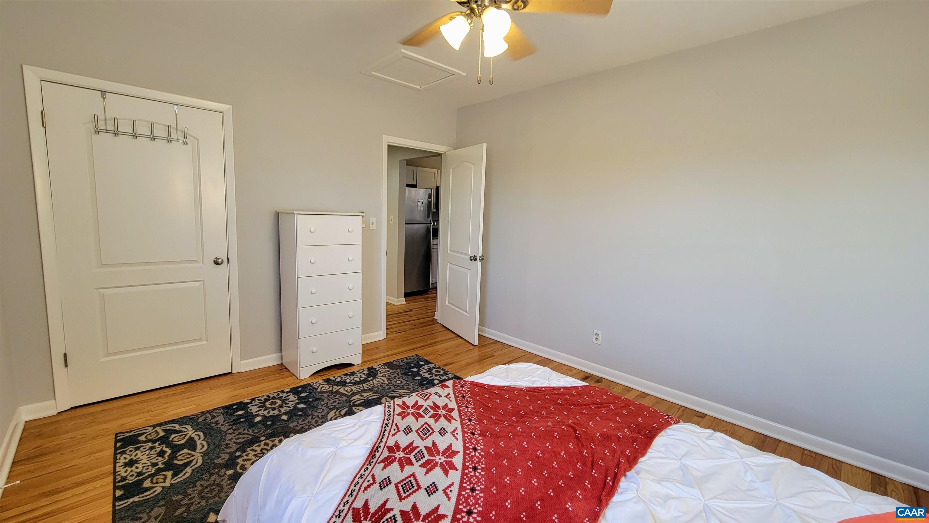 1511 East High Street, Unit 1 Charlottesville, VA 22902 - Photo 11 of 19 a bedroom with a bed and a chandelier