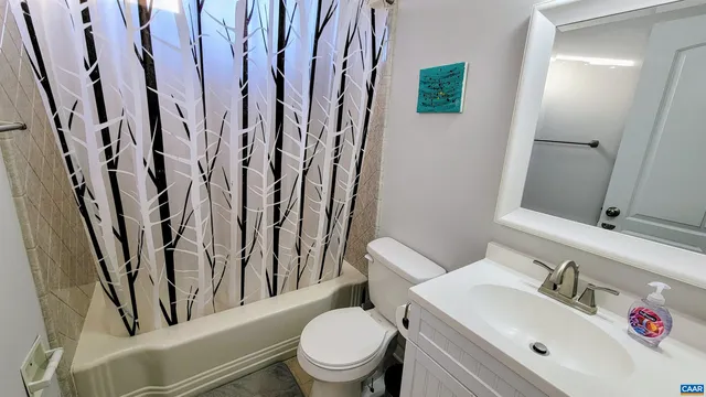 a white toilet sitting next to a bathroom sink