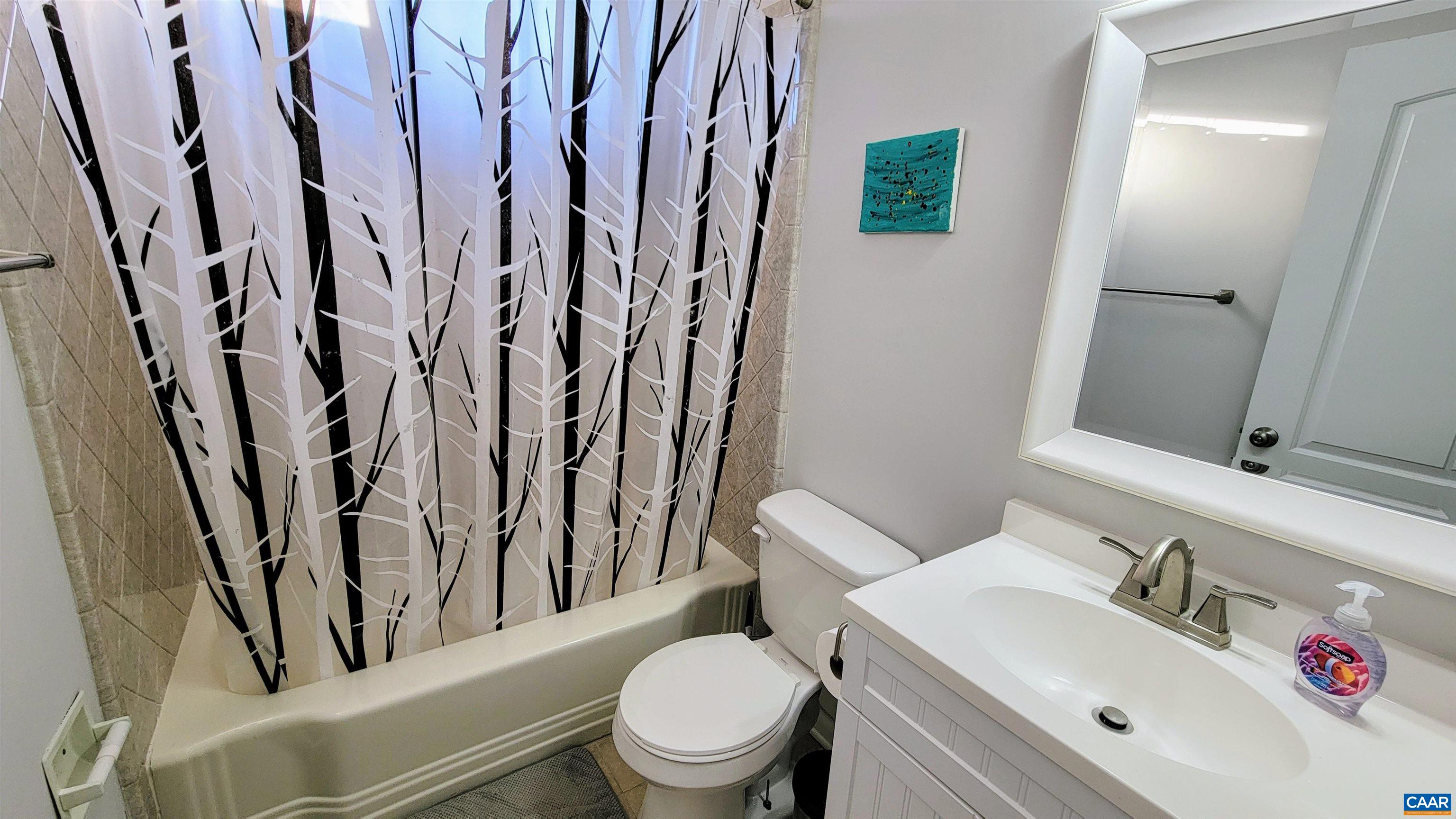 1511 East High Street, Unit 1 Charlottesville, VA 22902 - Photo 8 of 19 a white toilet sitting next to a bathroom sink