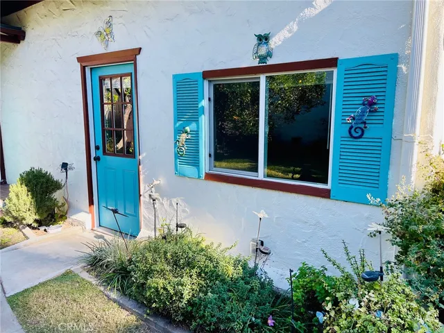 front view of a house with potted plants