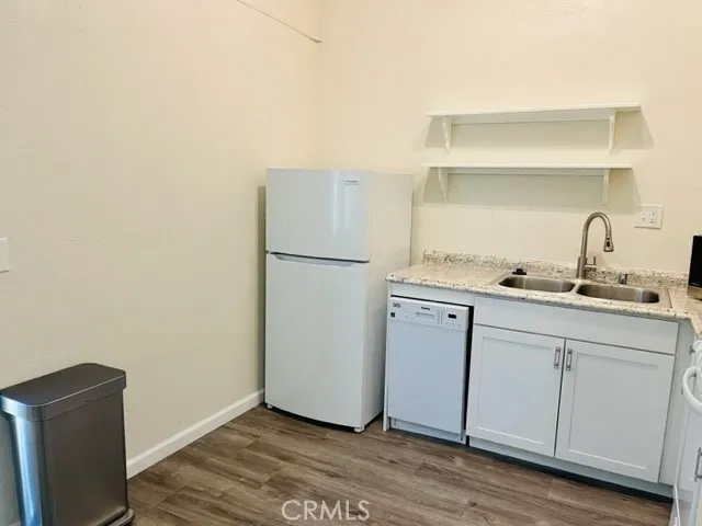 a kitchen with a refrigerator and cabinets