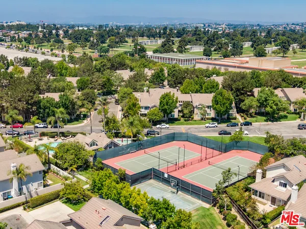 an aerial view of a houses with a swimming pool