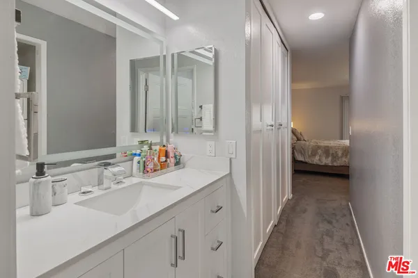 a en suite bathroom with a sink a mirror and a shower