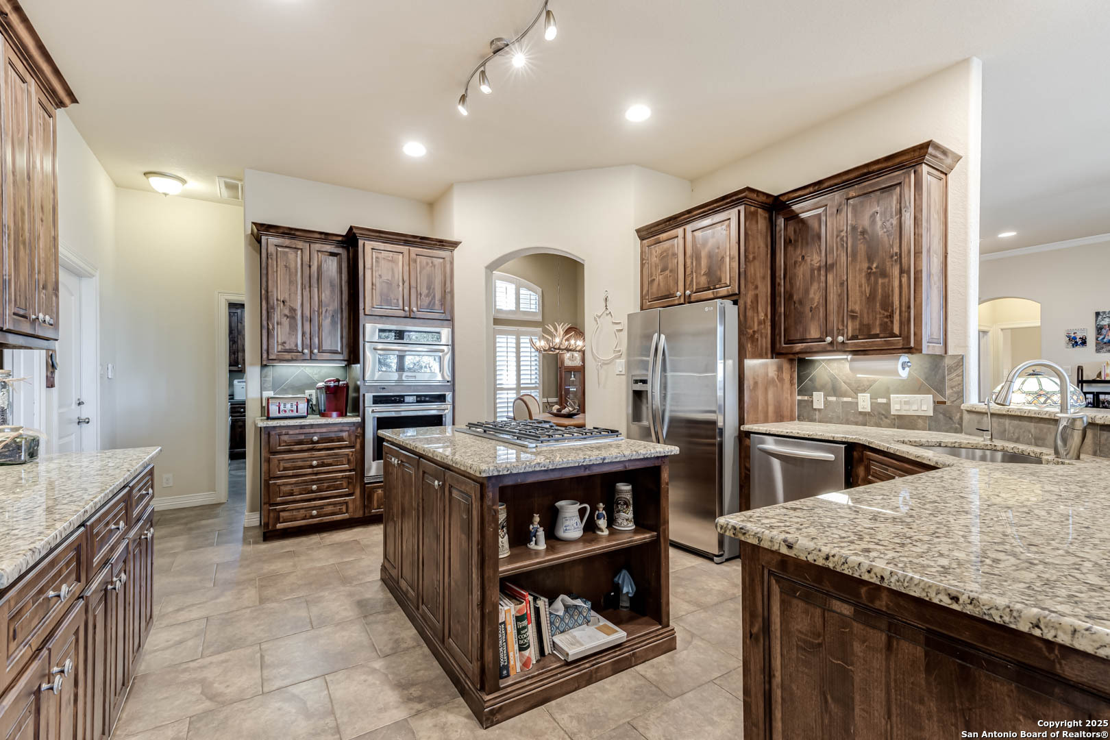 160 Gadwall Way Spring Branch, TX 78070 - Photo 2 of 45 a kitchen with stainless steel appliances granite countertop a stove refrigerator and cabinets