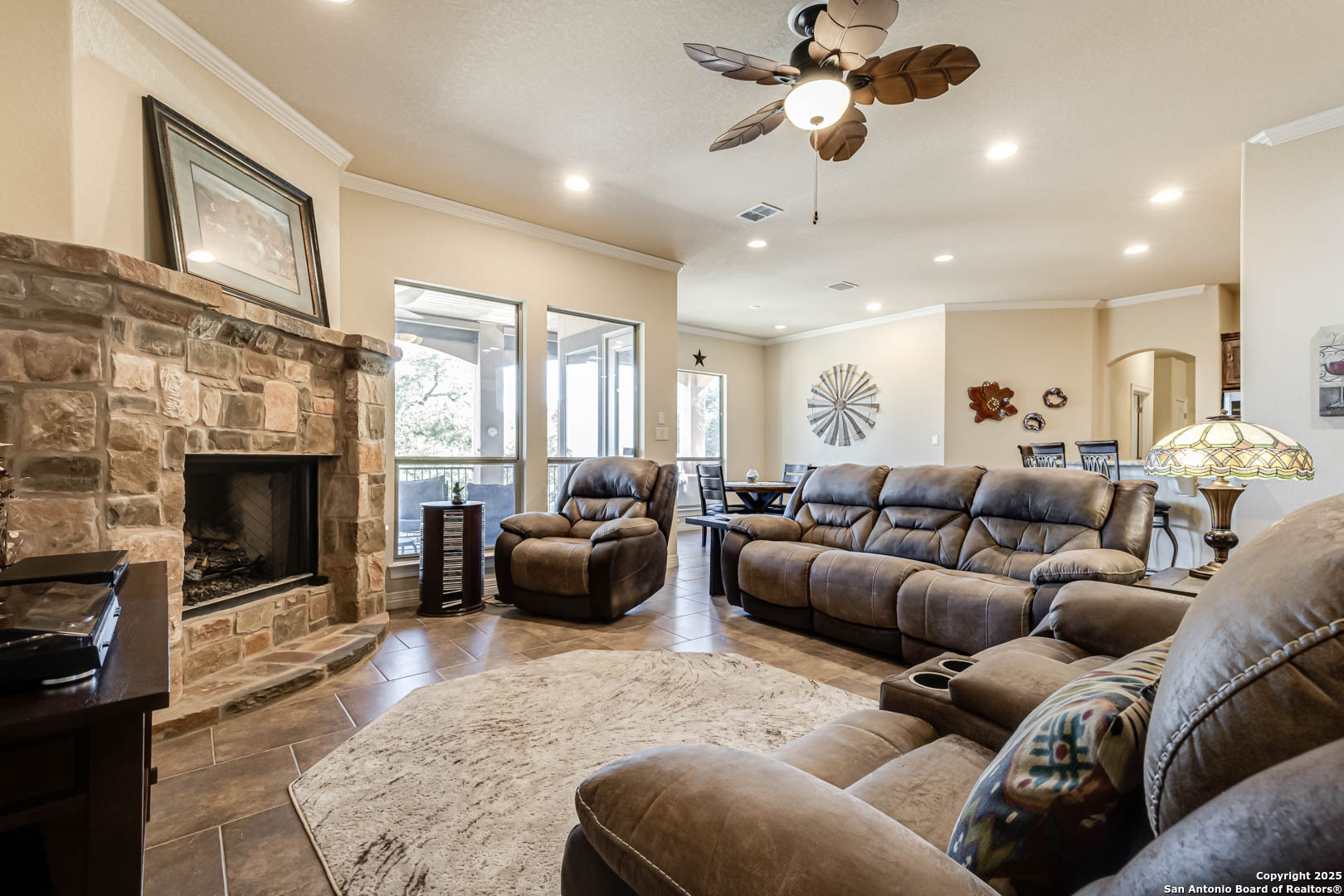 160 Gadwall Way Spring Branch, TX 78070 - Photo 7 of 45 a living room with furniture a fireplace and a ceiling fan