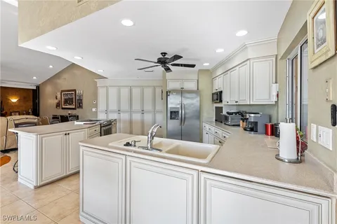 a kitchen with sink cabinets and window