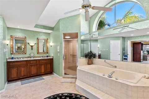 a spacious bathroom with a granite countertop tub sink and mirror