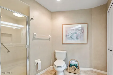 a bathroom with a toilet and a shower