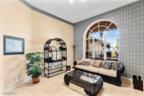 a living room with furniture a couch and a potted plant
