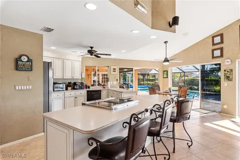 a kitchen with a table chairs and a refrigerator