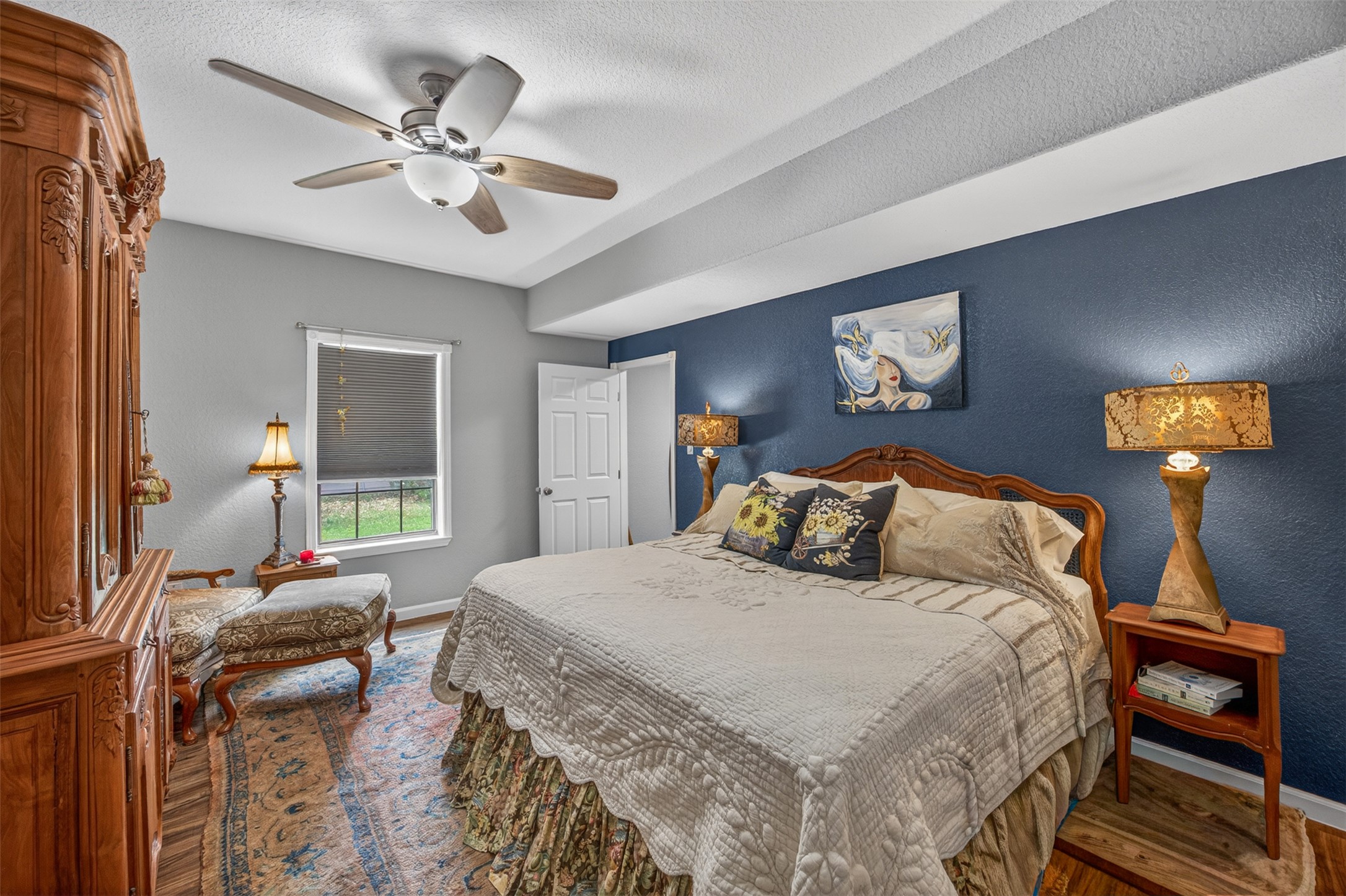 217 Walnut Avenue Luling, TX 78648 - Photo 14 of 38 a bedroom with a bed and a chandelier