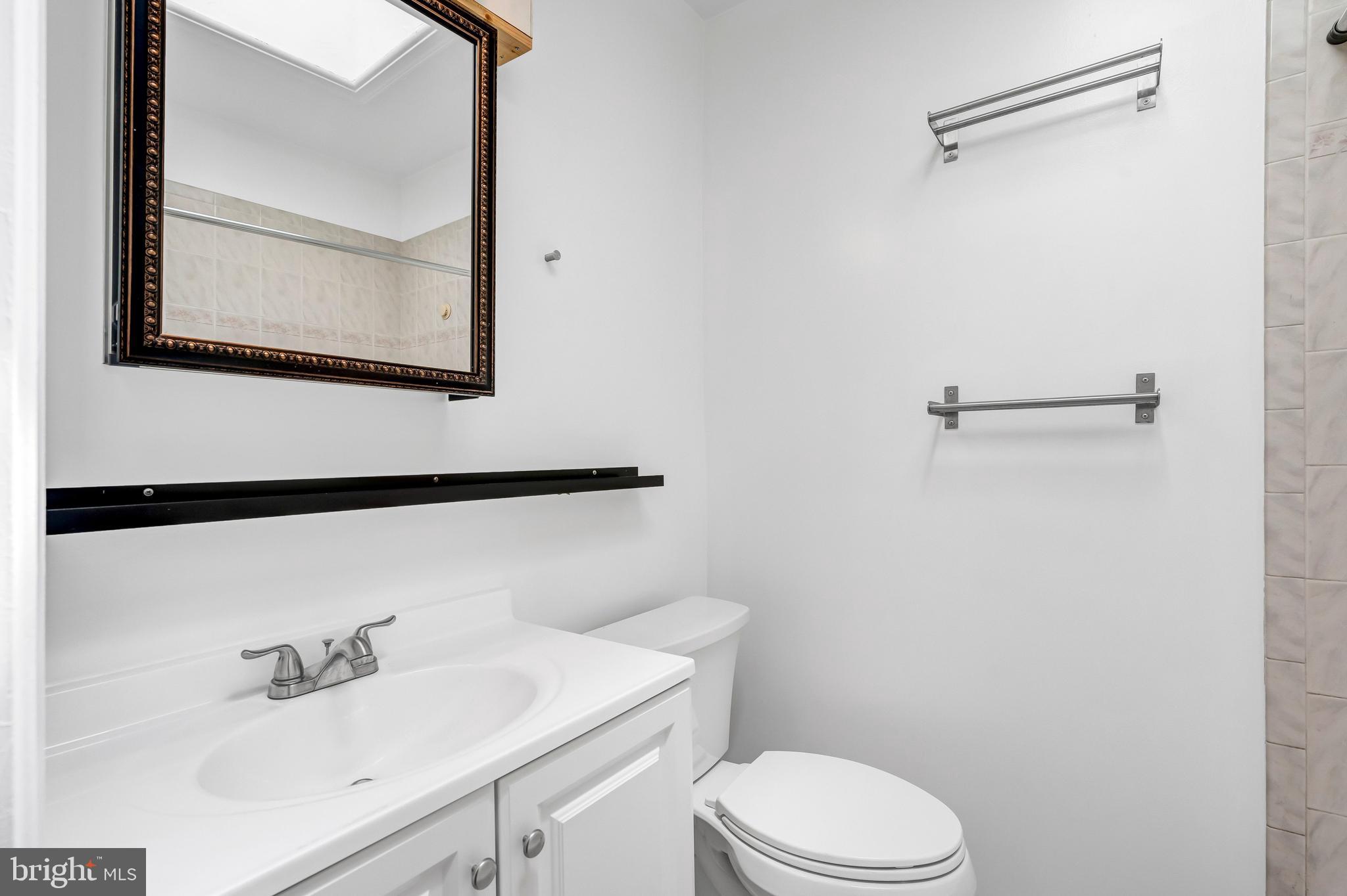 1749 L Street Northeast Washington, DC 20002 - Photo 16 of 24 a bathroom with a sink vanity mirror and toilet