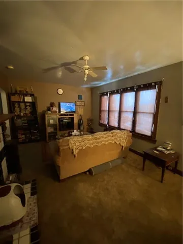 a spacious bedroom with a bed window and a table in it