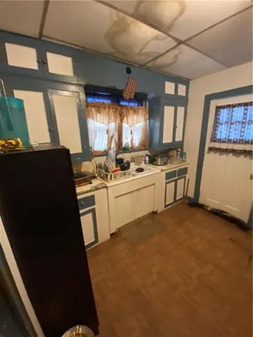 a kitchen with a stove a sink and a refrigerator