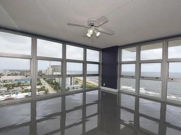 531 North Ocean Boulevard, Unit 1911 Pompano Beach, FL 33062 - Photo 12 of 34 a view of a livingroom with a ceiling fan and a large window with ceiling fan