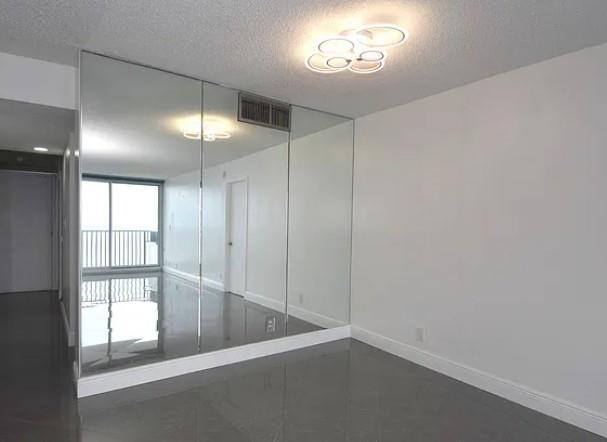531 North Ocean Boulevard, Unit 1911 Pompano Beach, FL 33062 - Photo 18 of 34 an empty room with a empty space and a window