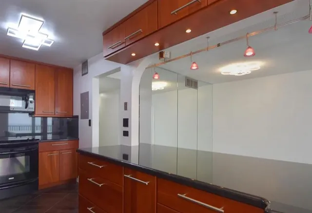 a kitchen with stainless steel appliances granite countertop a refrigerator and a sink