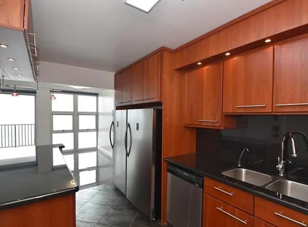531 North Ocean Boulevard, Unit 1911 Pompano Beach, FL 33062 - Photo 9 of 34 a kitchen with stainless steel appliances granite countertop a refrigerator and a sink