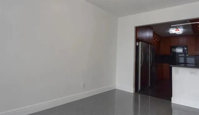 a view of a livingroom with a ceiling fan and a large window with ceiling fan