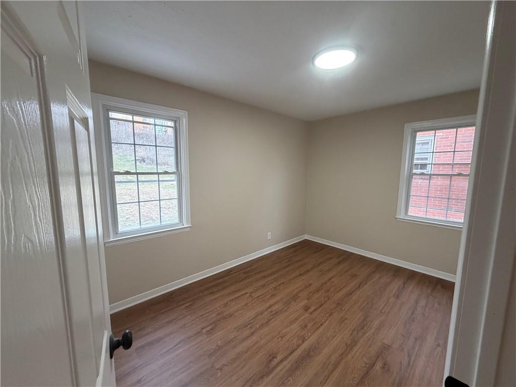 315 Caperton Street Pittsburgh, PA 15210 - Photo 11 of 16 an empty room with wooden floor and windows