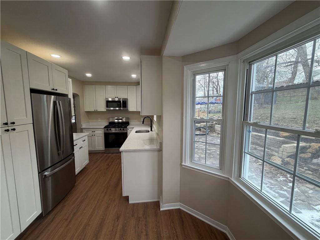315 Caperton Street Pittsburgh, PA 15210 - Photo 13 of 16 a kitchen with refrigerator a sink and a large window