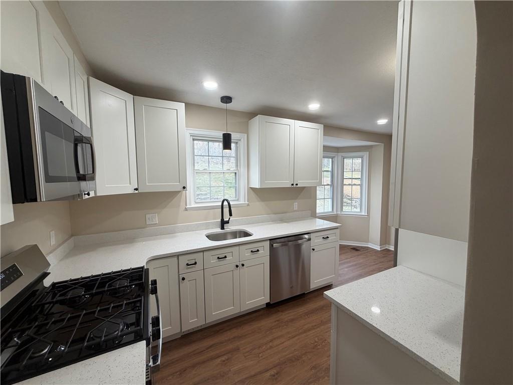 315 Caperton Street Pittsburgh, PA 15210 - Photo 9 of 16 a kitchen with a sink stove and cabinets