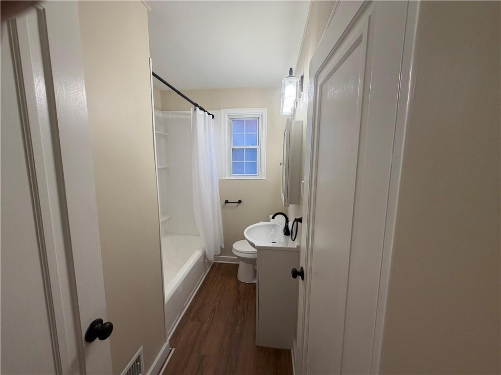 315 Caperton Street Pittsburgh, PA 15210 - Photo 10 of 16 a bathroom with a sink and mirror with toilet