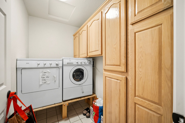 1985 West Rivers Edge Lane St. George, UT 84770 - Photo 33 of 42 Laundry area with cabinet space, light tile patterned floors, and independent washer and dryer