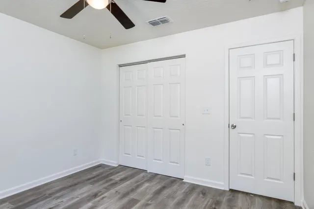 an empty room with a ceiling fan