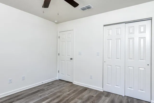 an empty room with a ceiling fan