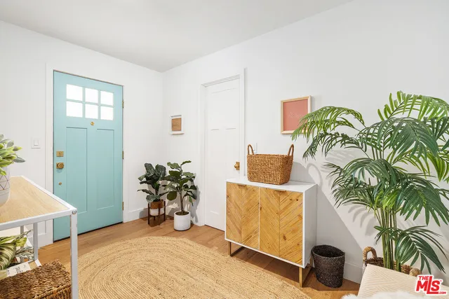 a view of a livingroom with furniture and a potted plant