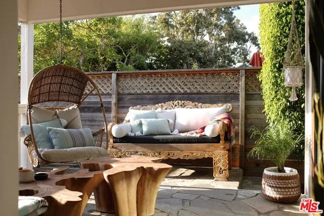 a view of a patio with table and chairs potted plants