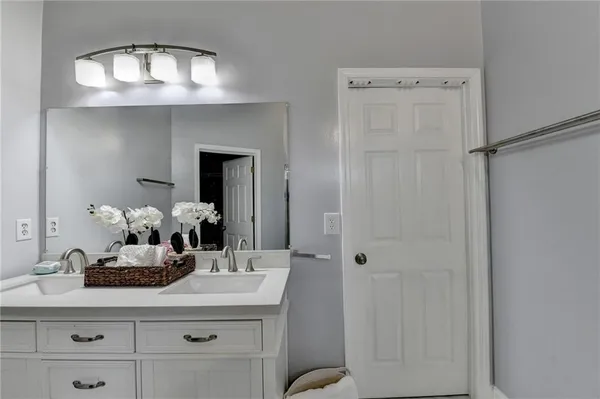a bathroom with a sink vanity and a mirror