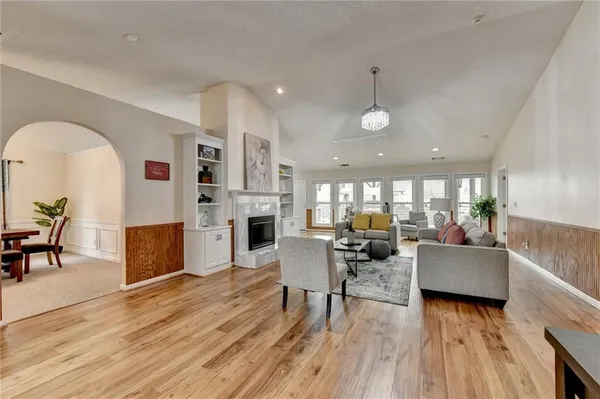 a living room with fireplace furniture and a wooden floor