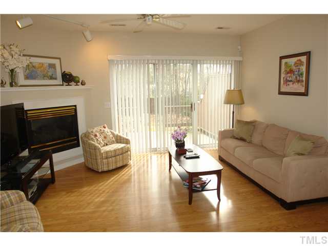 4203 Sunscape Lane Raleigh, NC 27613 - Photo 2 of 15 a living room with furniture and a fireplace