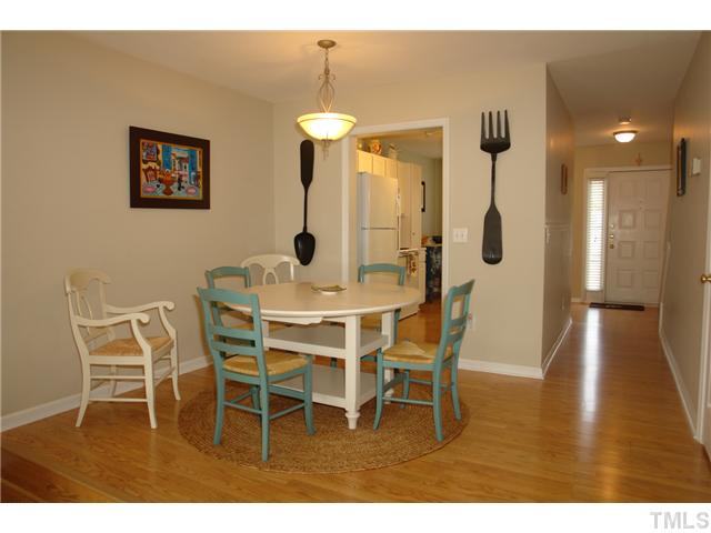 4203 Sunscape Lane Raleigh, NC 27613 - Photo 3 of 15 a dining room with furniture and wooden floor
