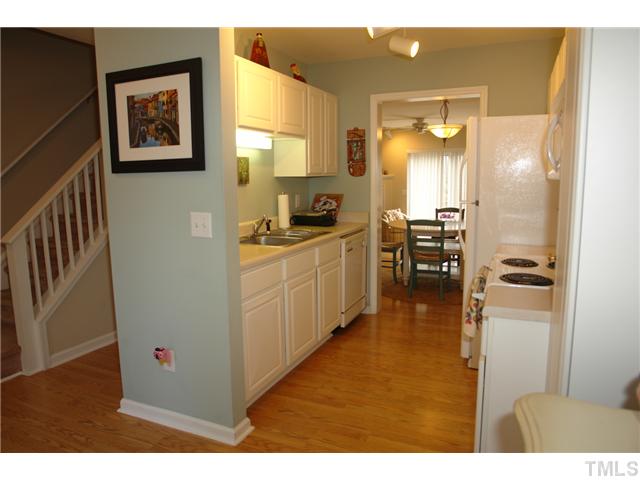 4203 Sunscape Lane Raleigh, NC 27613 - Photo 4 of 15 a kitchen with stainless steel appliances a stove a sink and a refrigerator
