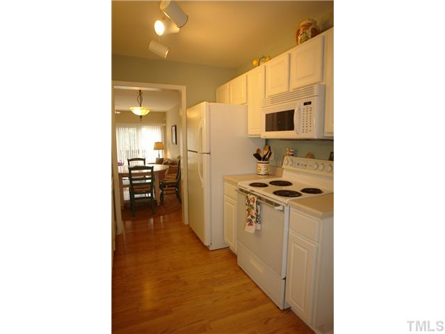 4203 Sunscape Lane Raleigh, NC 27613 - Photo 5 of 15 a kitchen with stainless steel appliances a sink and a refrigerator