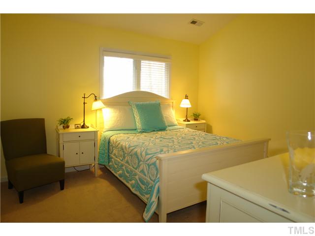 4203 Sunscape Lane Raleigh, NC 27613 - Photo 7 of 15 a bedroom with a bed and wooden floor