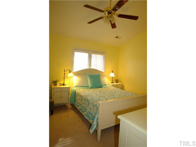 4203 Sunscape Lane Raleigh, NC 27613 - Photo 8 of 15 a bedroom with a bed and a painting on the wall